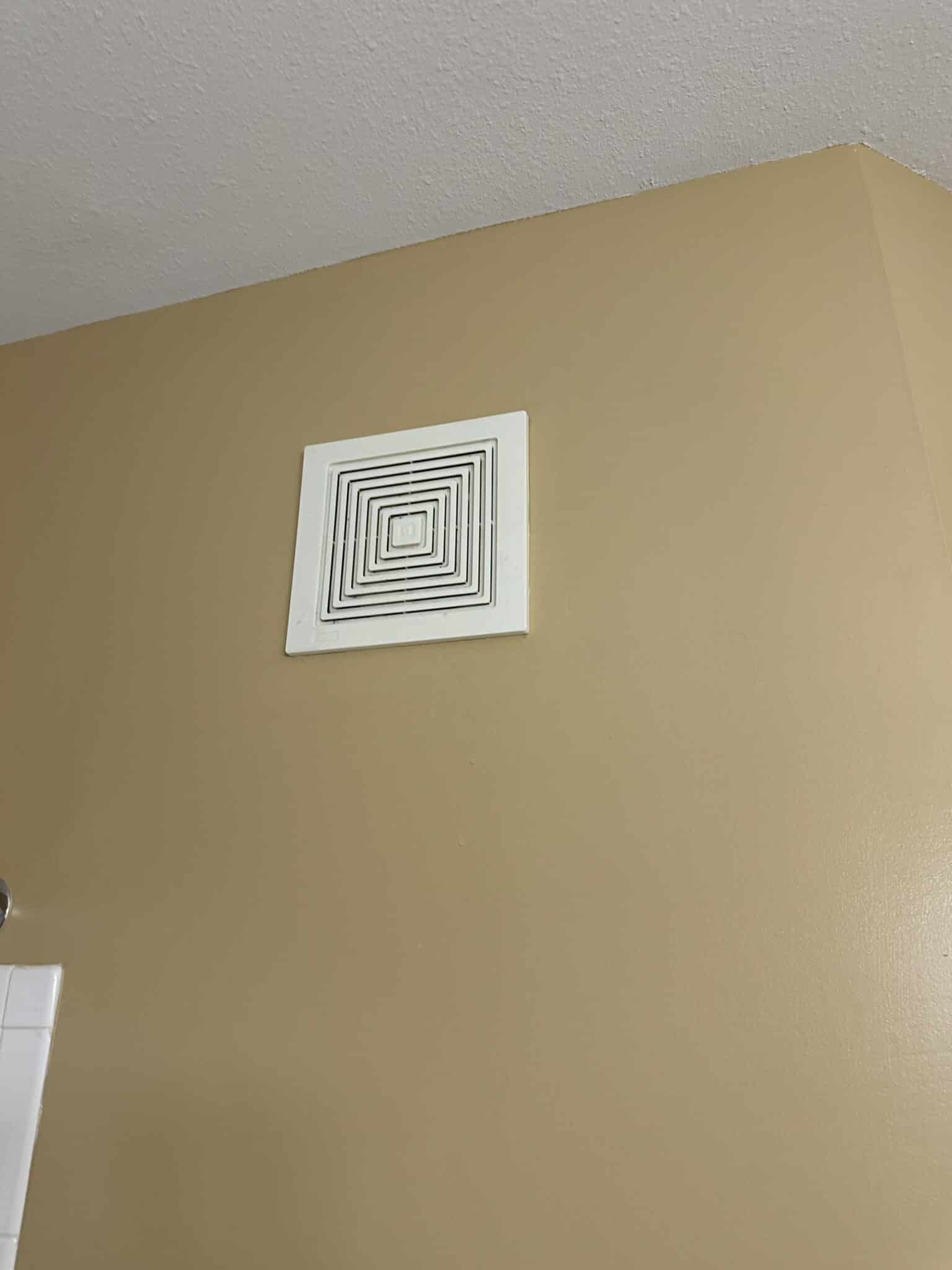 Broan bathroom exhaust fan grille installed flush on a bathroom ceiling