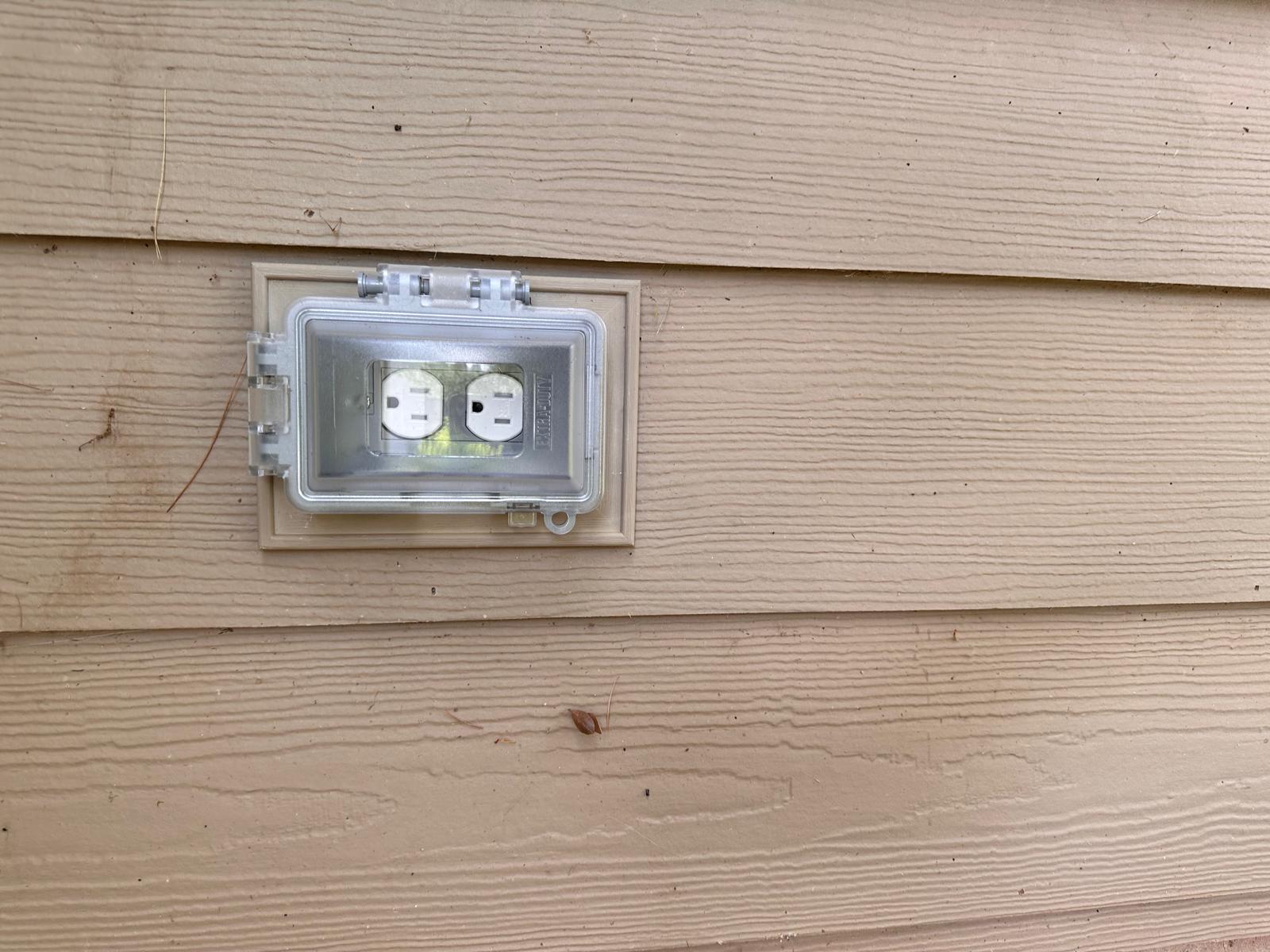 New outdoor outlet with in-use bubble weatherproof cover after replacement