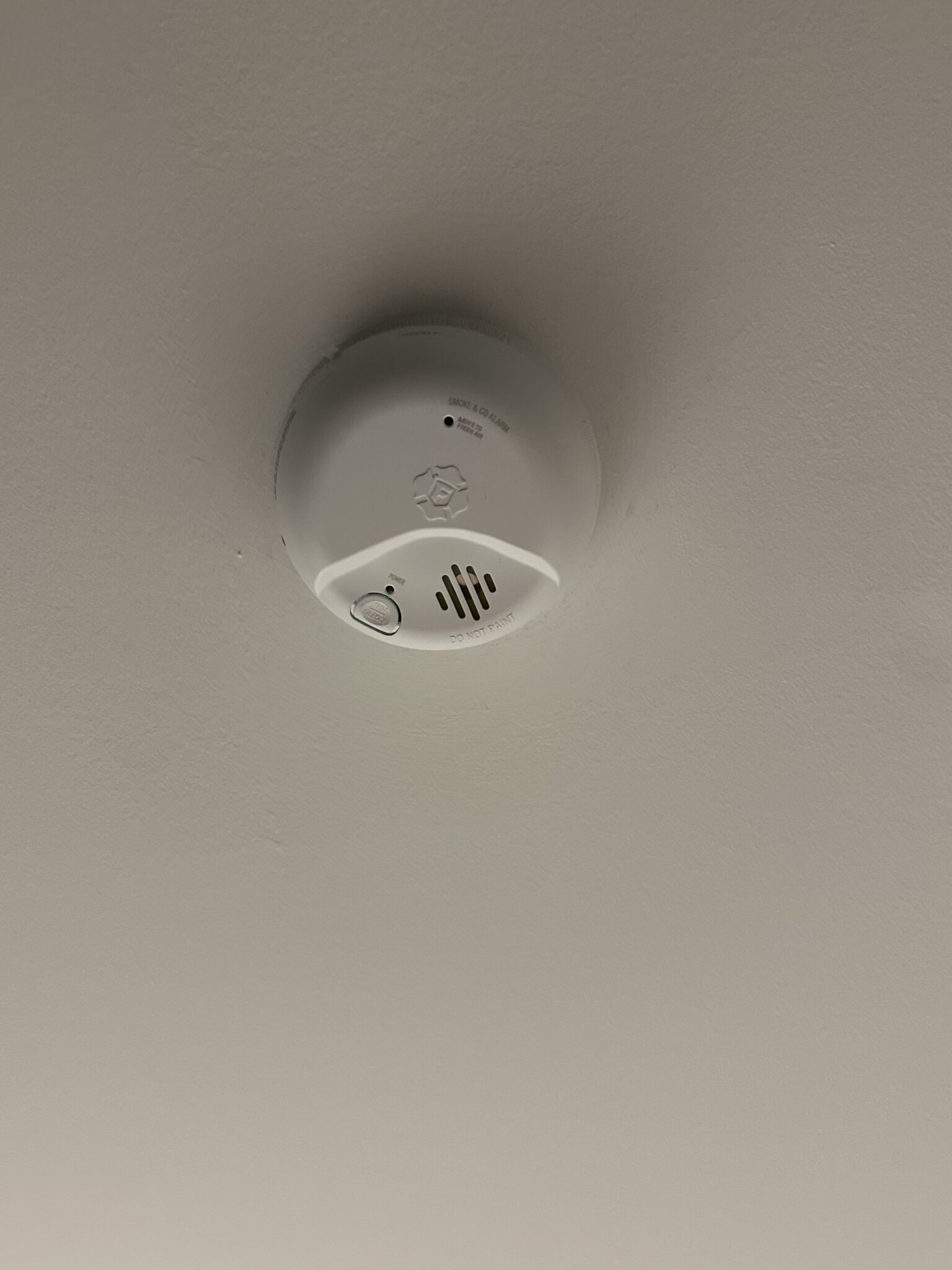 Hardwired smoke and carbon monoxide combo detector mounted on a residential ceiling